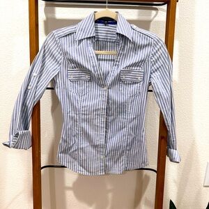 Women’s fitted blue and white striped button down work shirt.